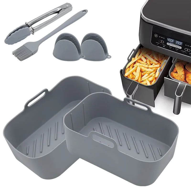 CrispNest silicone liners in use inside a dual-basket air fryer with fries and chicken